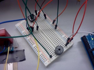 Closeup of the breadboard, with button and speaker