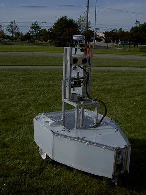 Kratos, large, light-gray robot with tall sensor system and triangular base sits in grass