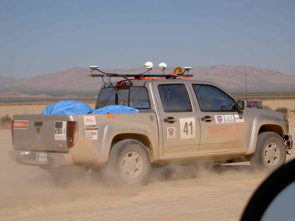 GMC truck self navigating in the desert, rear side view