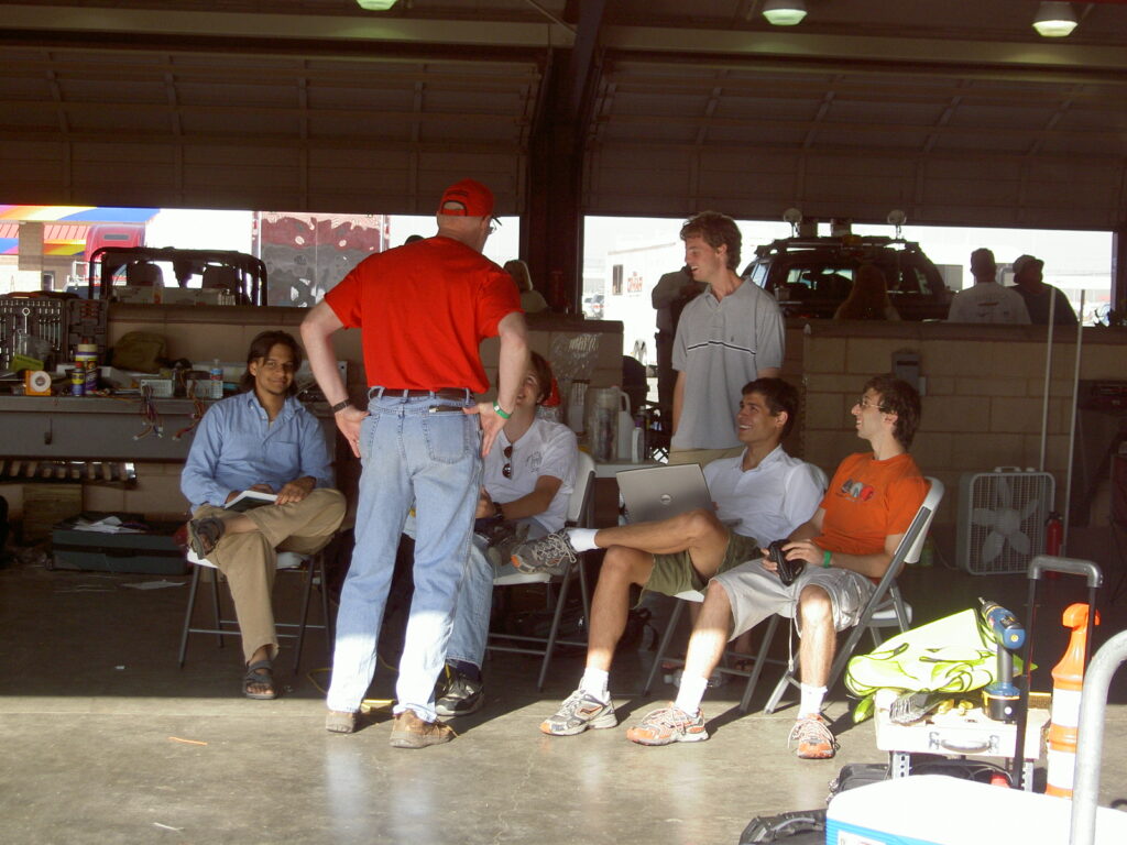 PAVE students discussing with Professor Kornhauser at DARPA competition