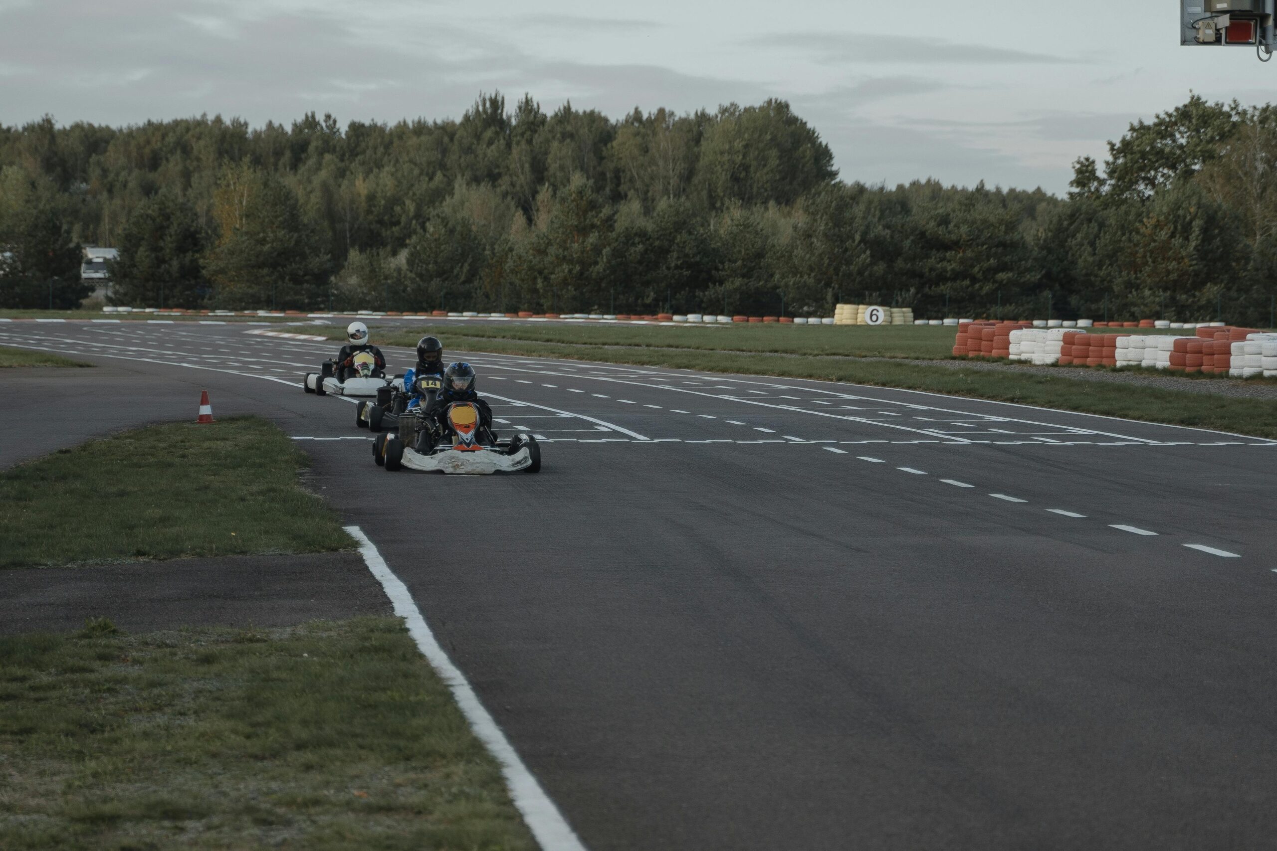 3 go-kart racers in line as they race on a track