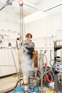 Graduate student Max Hirschberger lowers the assembled experimental setup into a high-field magnet system, capable of creating fields as strong as 250,000 times the earth's magnetic field.  (Image credit: Jason Krizan.)