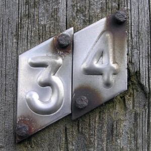 metal house number (34) with rusted nails, photo by LEOL30 on Flickr